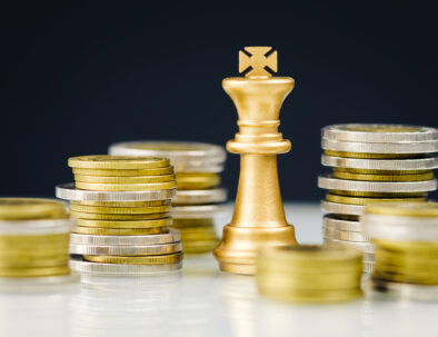 Golden king chess among the heaps of coins, financial planner, and business strategy concept